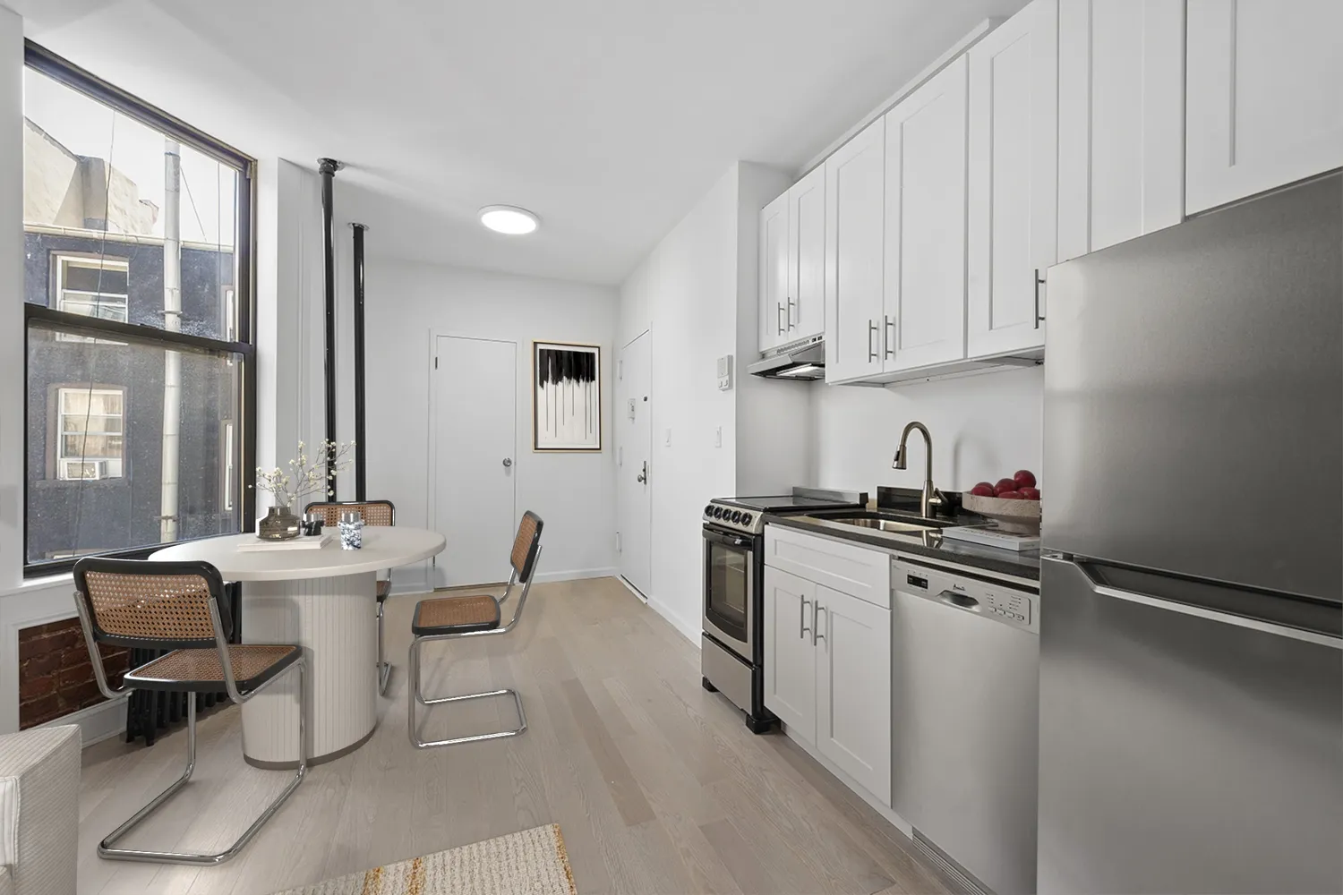 a kitchen with stainless steel appliances a sink stove and cabinets