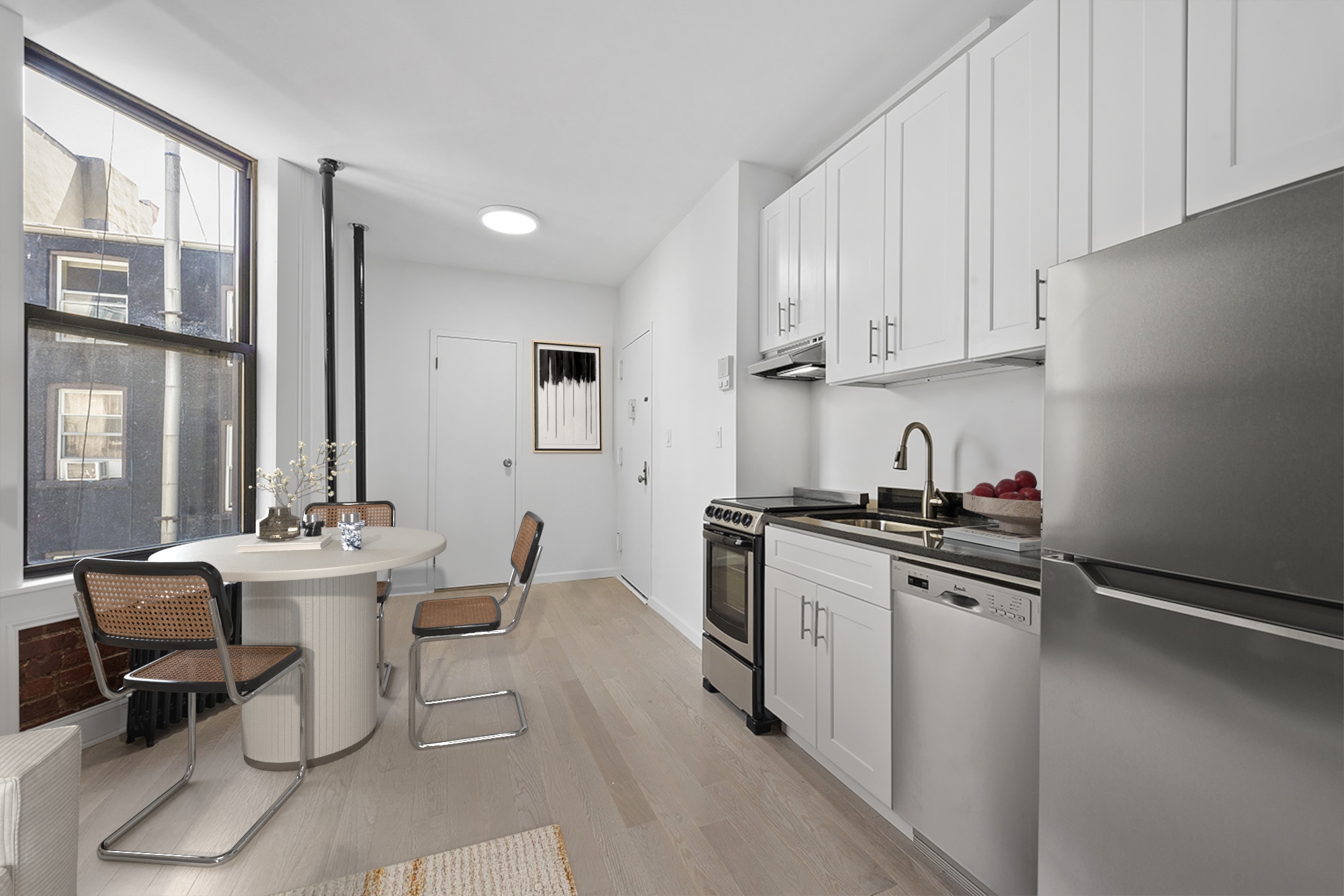 117 Mulberry Street, Unit 9 Manhattan, NY 10013 - Photo 4 of 5 a kitchen with stainless steel appliances a sink stove and cabinets
