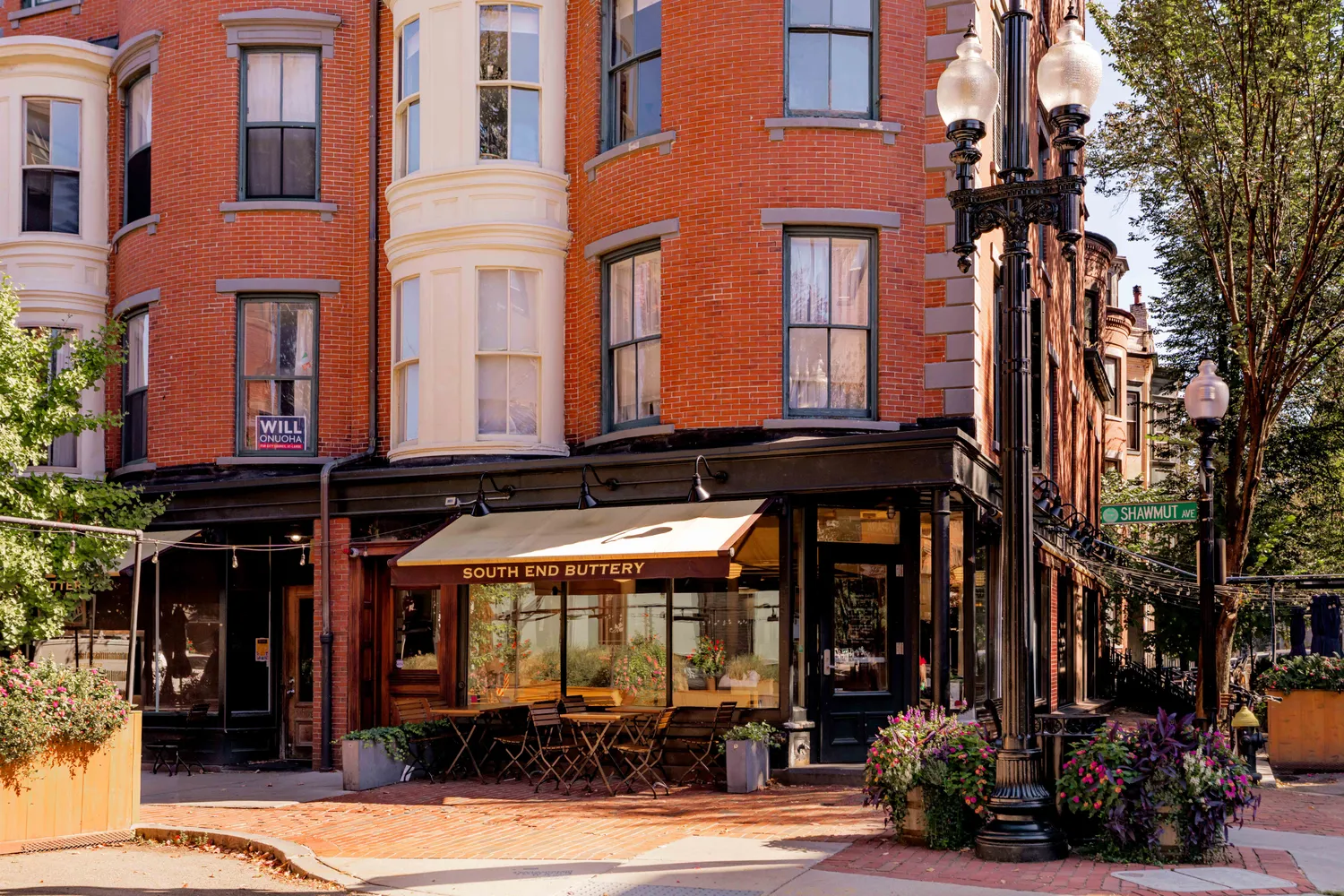 front view of a building with a lot of windows and plants