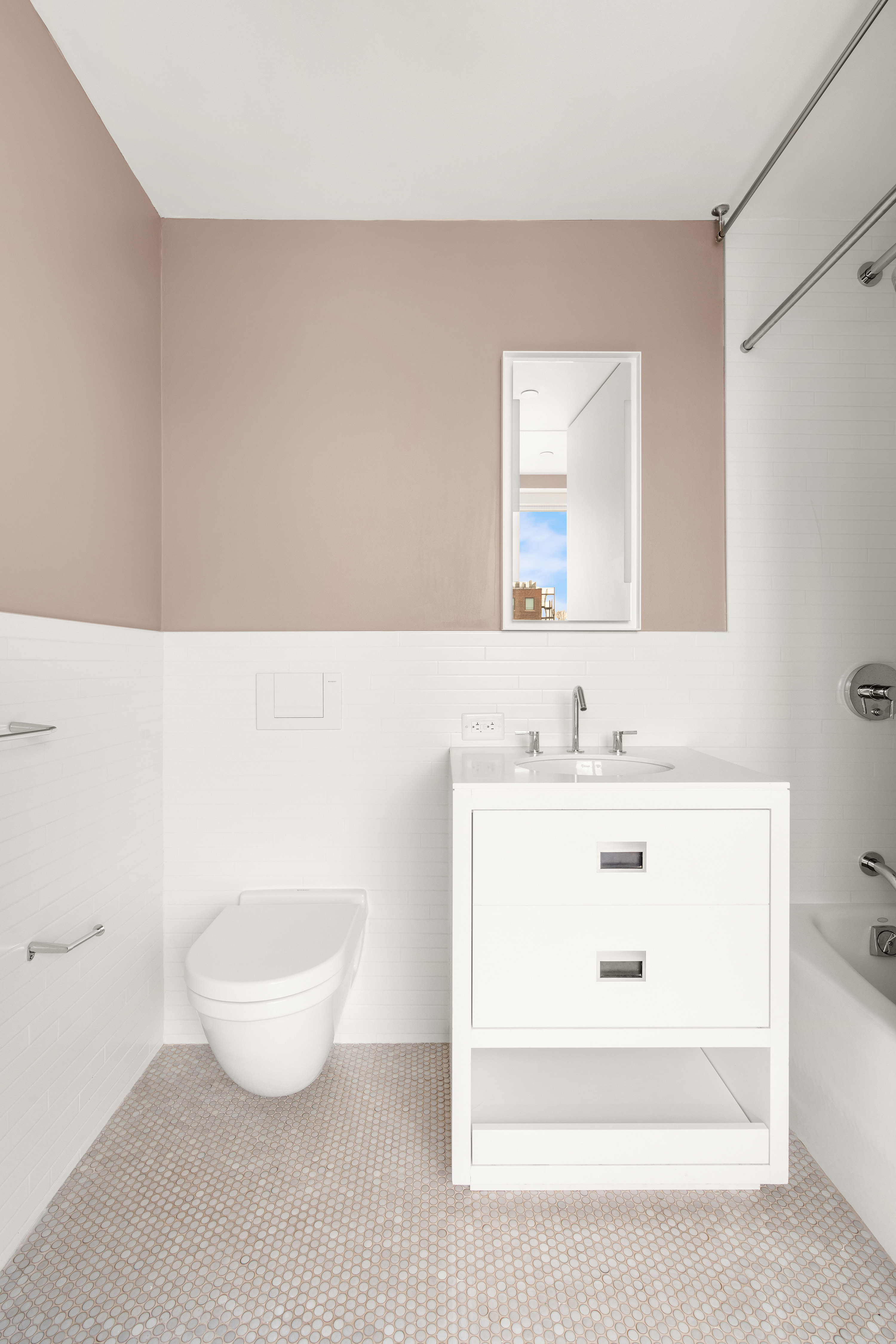 245 West 19th Street, Unit PH4 Manhattan, NY 10011 - Photo 8 of 13 a bathroom with a sink a mirror and a bathtub