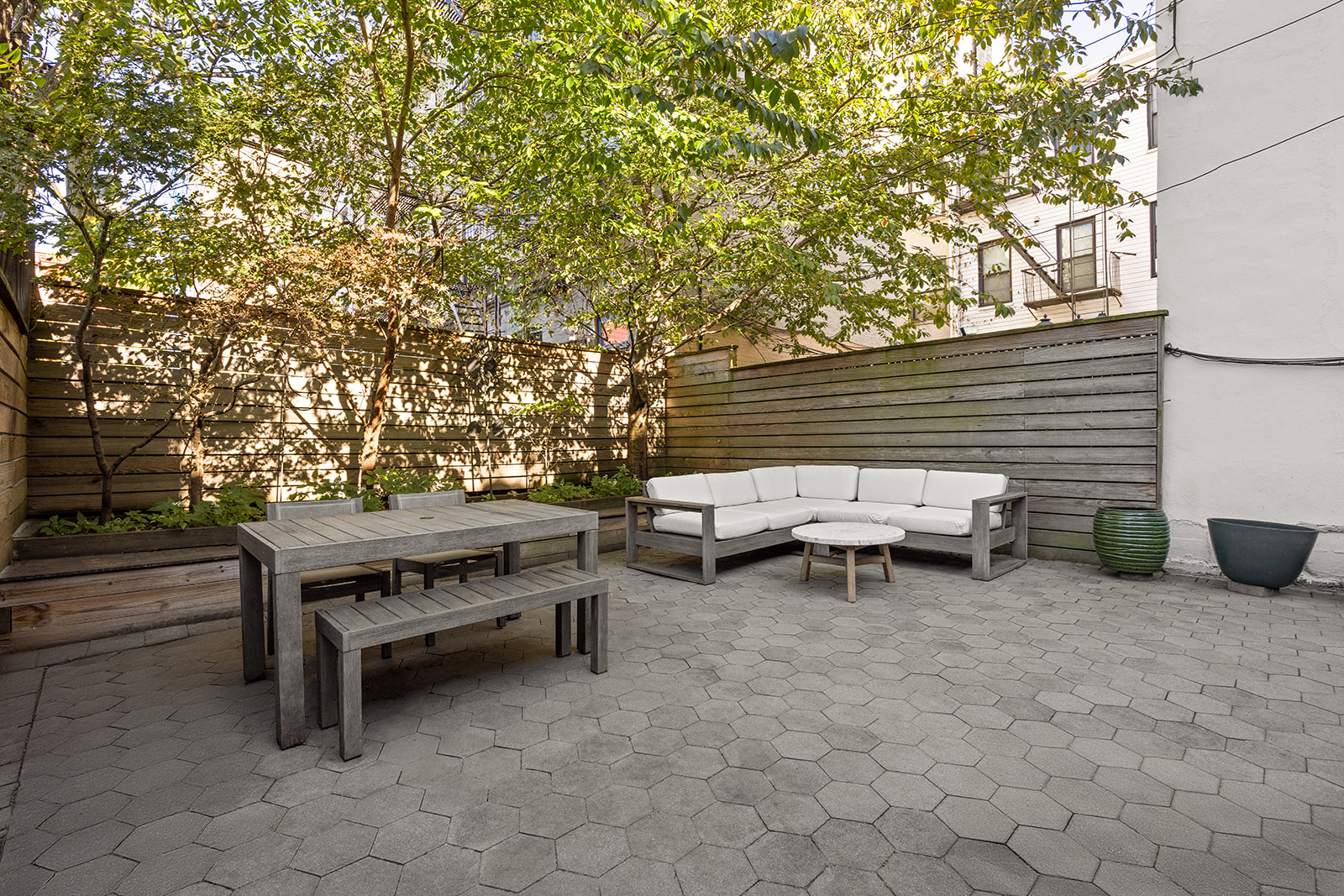 493 18th Street, Unit 2 Brooklyn, NY 11215 - Photo 10 of 13 a backyard of a house with barbeque oven and outdoor seating
