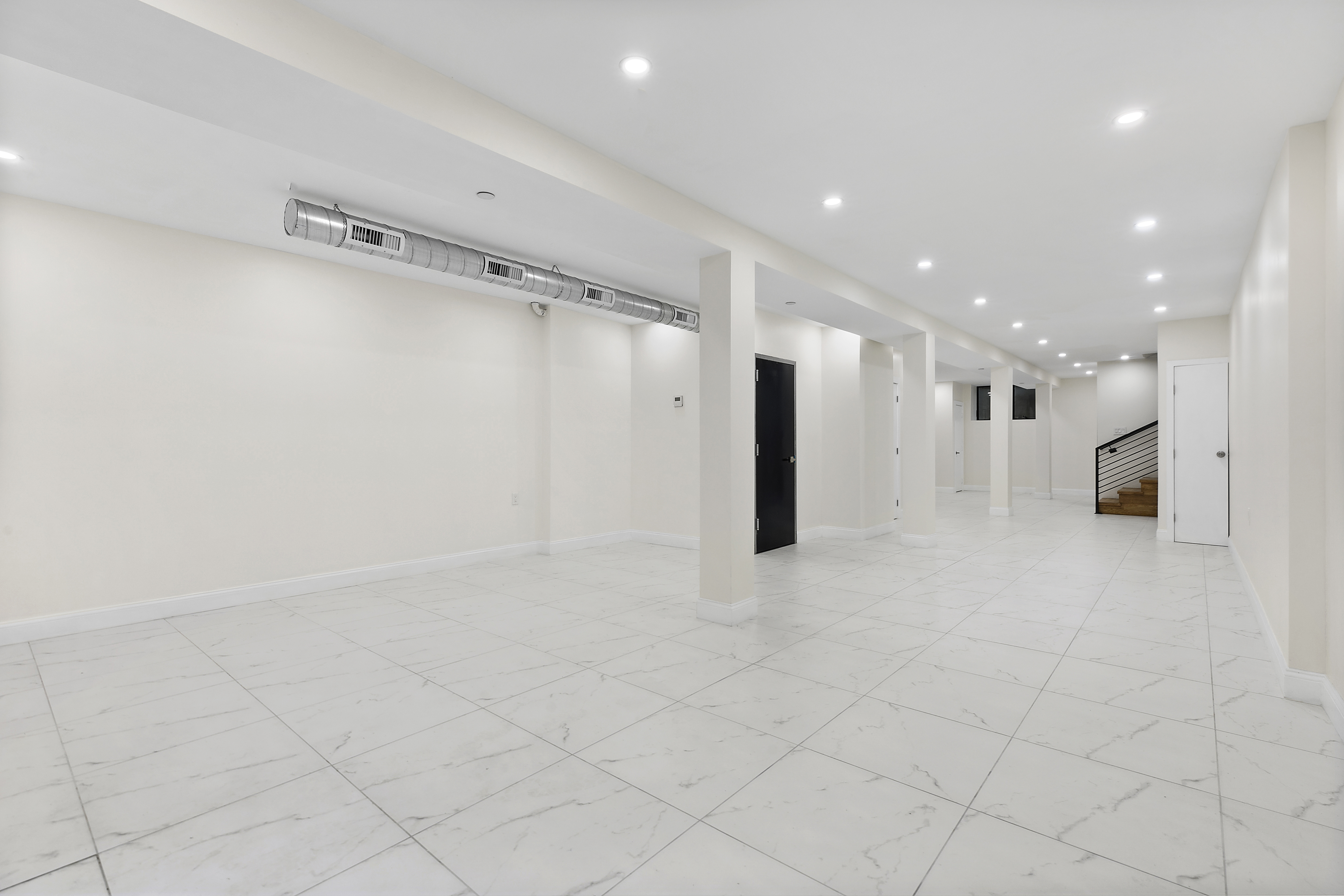 35-17 30th Street, Unit GARDEN Queens, NY 11106 - Photo 11 of 14 a view of a big room with white doors