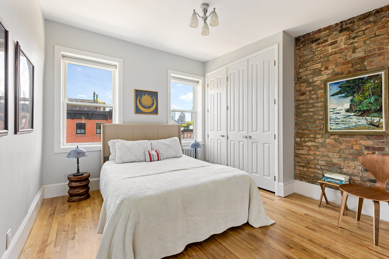 334 Union Street, Unit 3 Brooklyn, NY 11231 - Photo 4 of 10 a bedroom with a bed and a table in it with wooden floor
