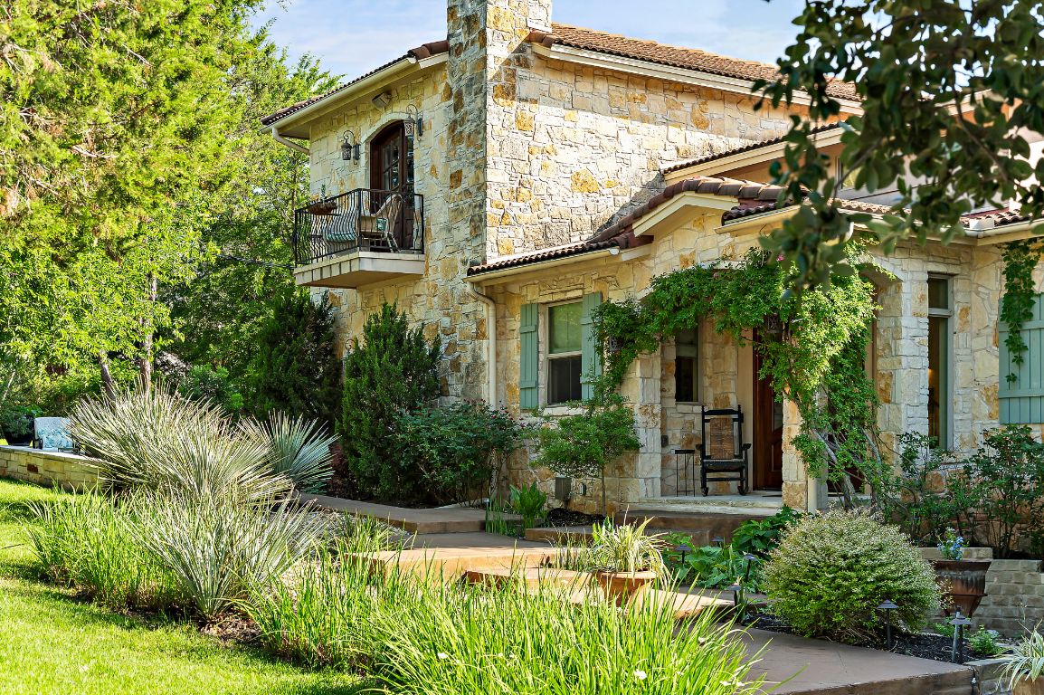 1607 The High Road Austin, TX 78746 - Photo 3 of 28 a front view of a house with a yard