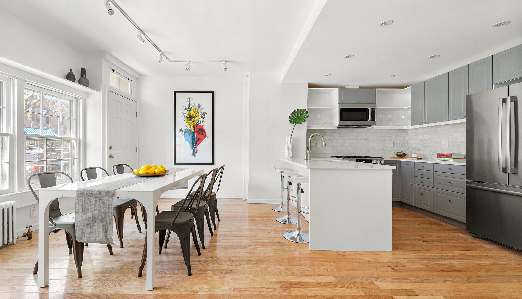 375 Van Brunt Street Brooklyn, NY 11231 - Photo 3 of 12 a kitchen with stainless steel appliances kitchen island granite countertop a refrigerator a stove a microwave oven a dining table and chairs with wooden floor