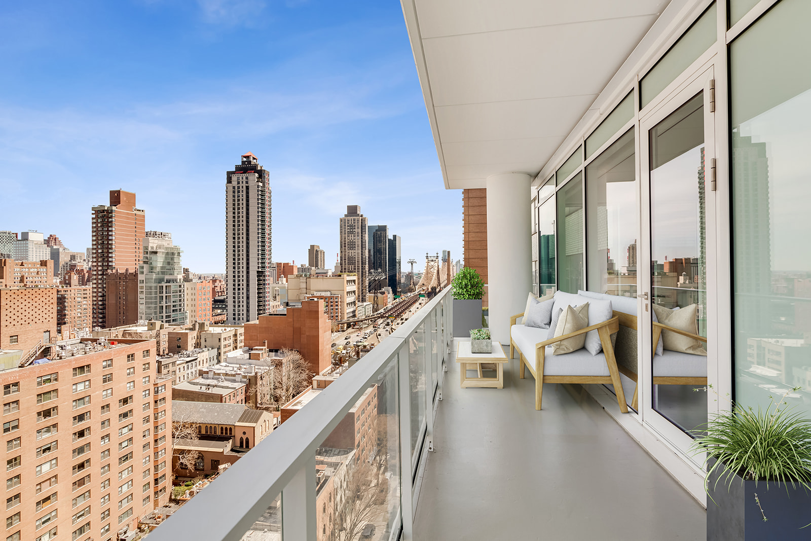 200 East 59th Street, Unit 11C Manhattan, NY 10022 - Photo 4 of 11 a balcony with furniture and view of city