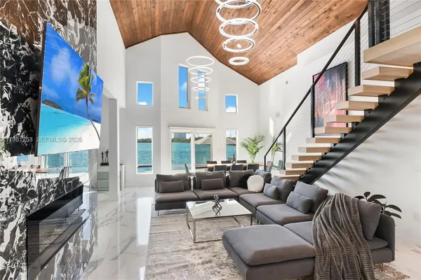 a living room with furniture and a chandelier