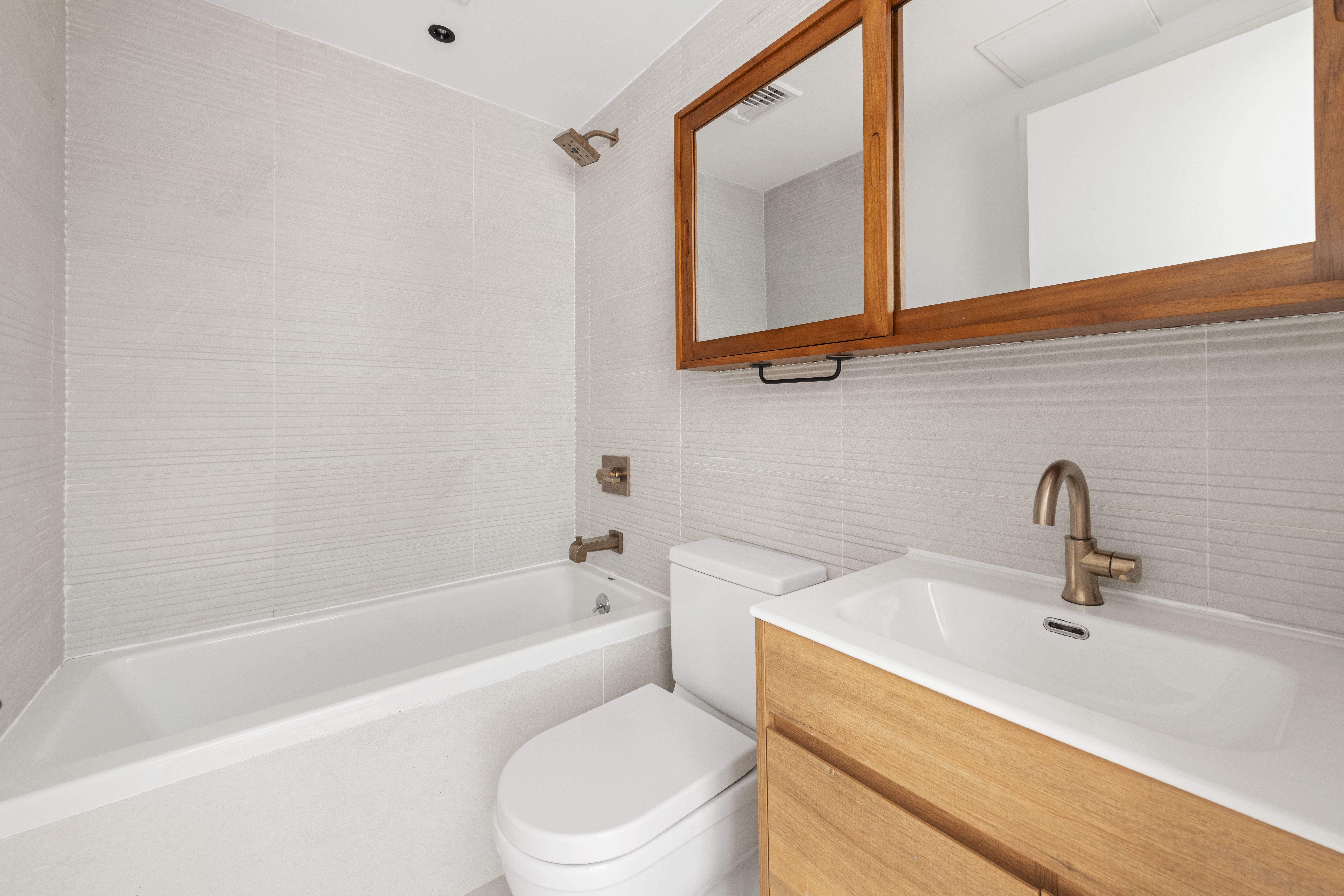 42 Rochester Avenue, Unit 3 Brooklyn, NY 11233 - Photo 14 of 18 a bathroom with a sink a toilet and shower