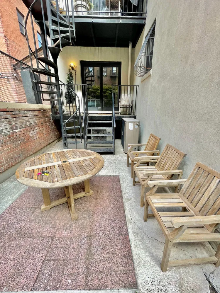 a view of a chairs and table in the patio