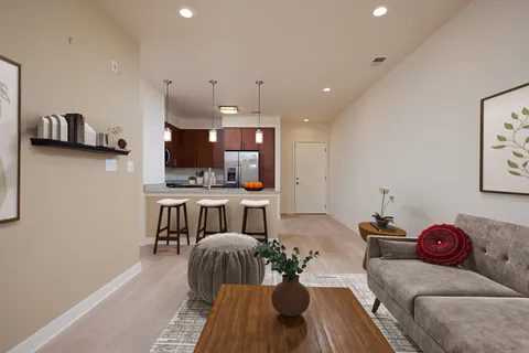 a living room with furniture and kitchen view