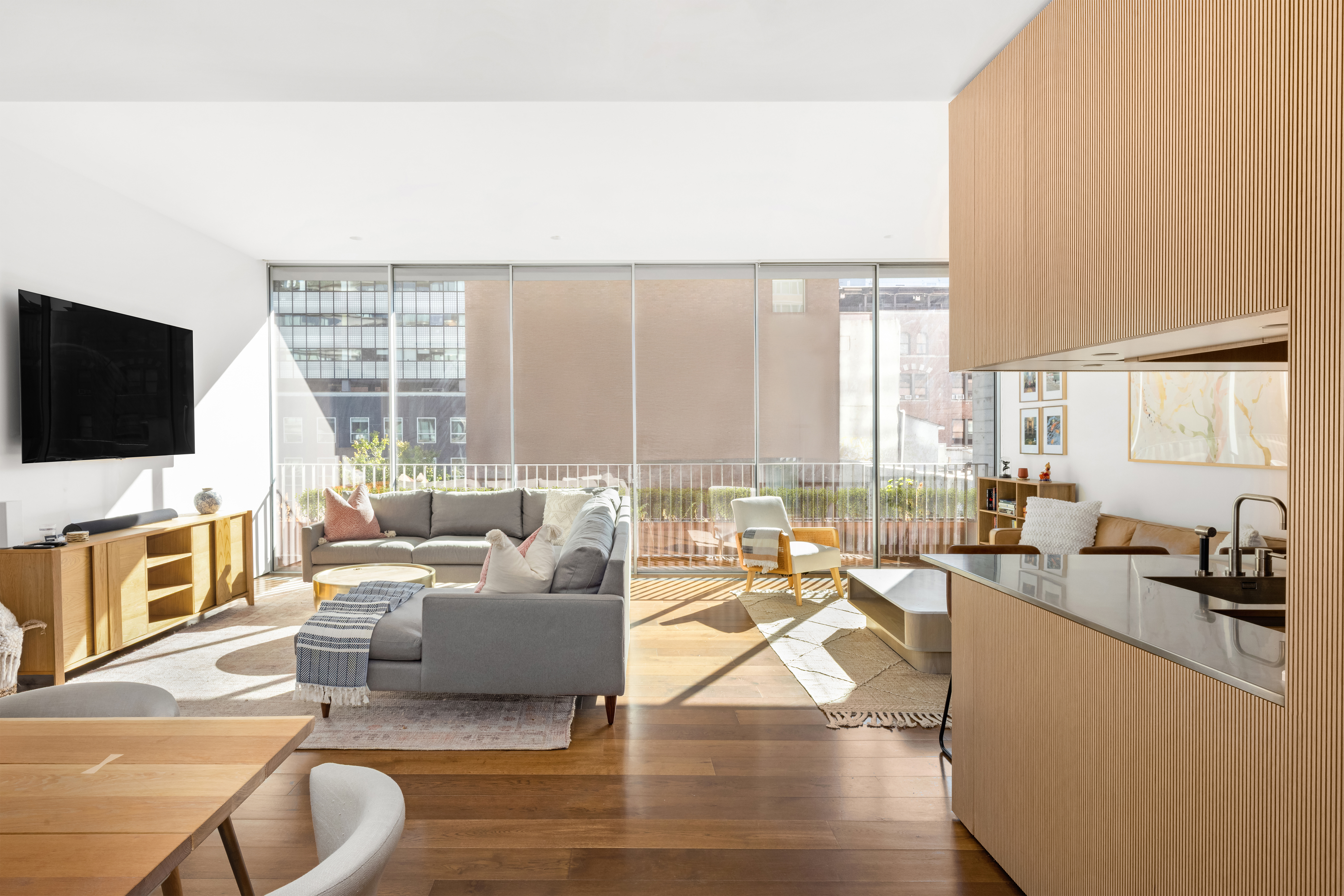 527 West 27th Street, Unit 4C Manhattan, NY 10001 - Photo 3 of 25 a living room with furniture and a flat screen tv