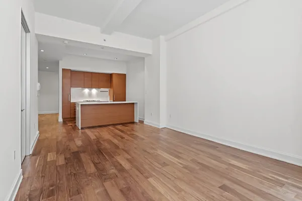a view of a room with wooden floor and a sink