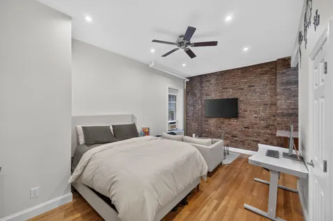 a bedroom with a bed and a flat screen tv