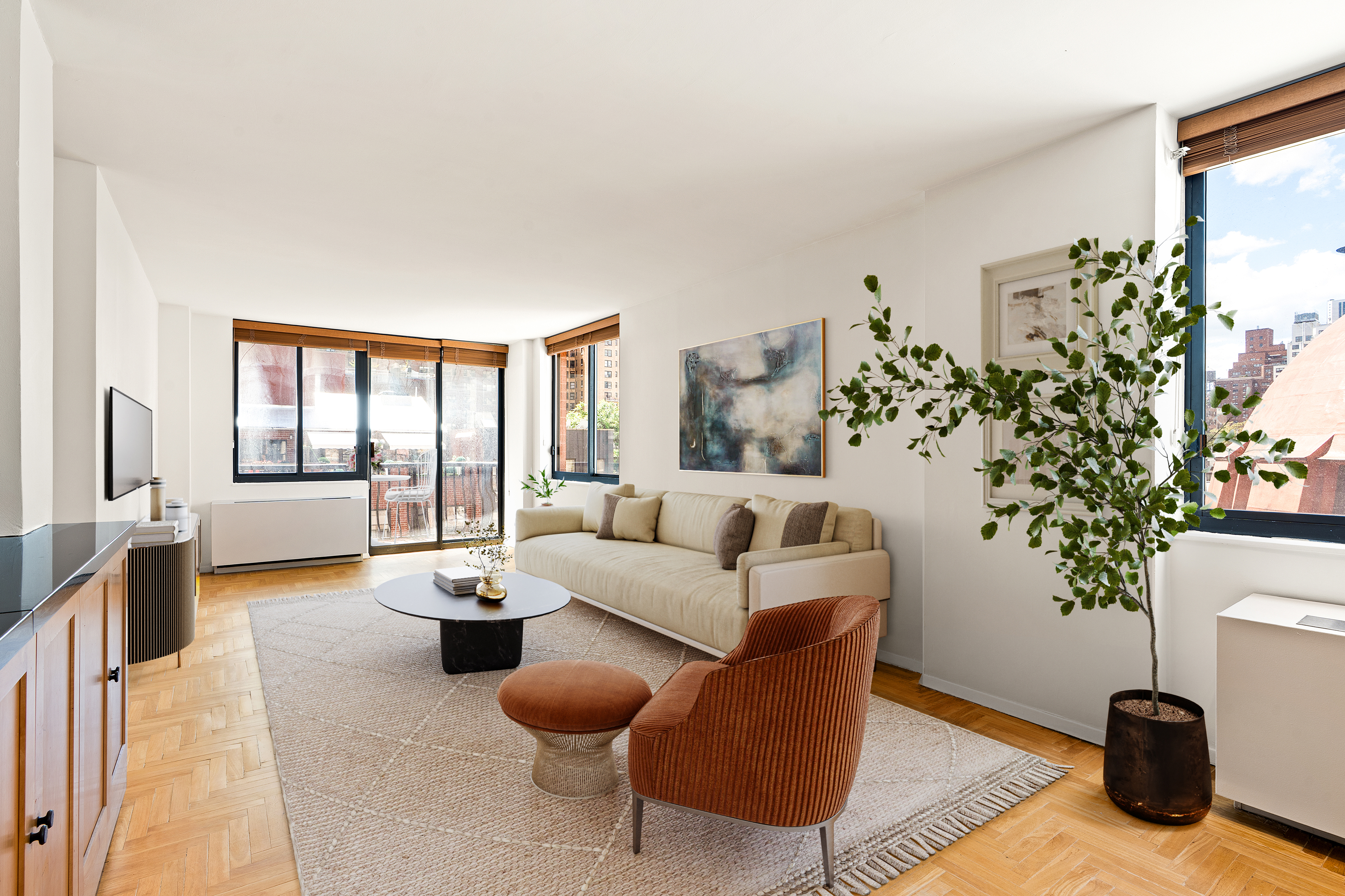 343 East 74th Street, Unit 7L Manhattan, NY 10021 - Photo 1 of 11 a living room with furniture potted plant and a chandelier