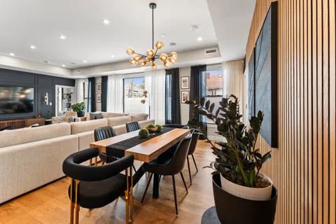 a view of a dining room with furniture and a chandelier