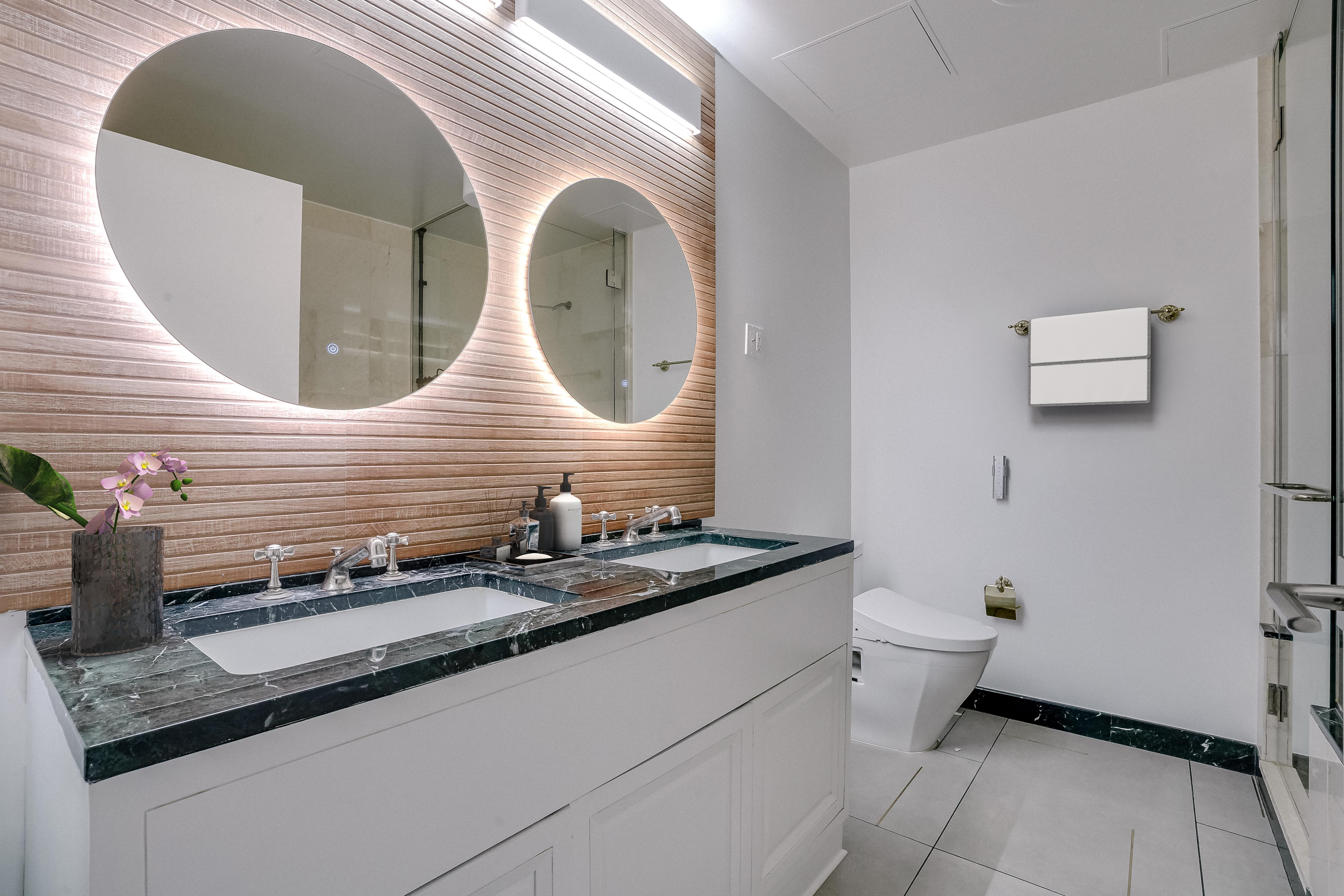 55 Wall Street, Unit PH910 Manhattan, NY 10005 - Photo 11 of 19 a bathroom with a sink and mirror