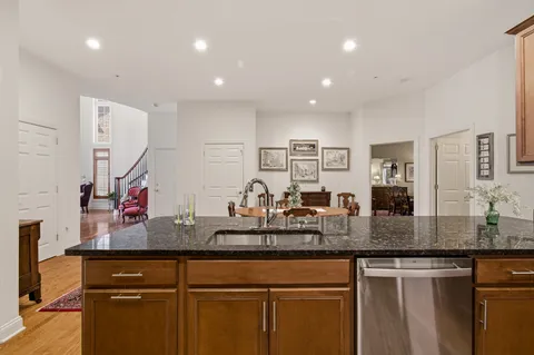 a living room with furniture a rug and kitchen view
