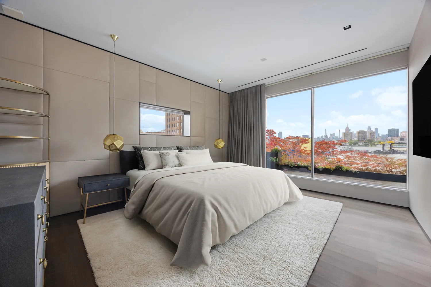 a bedroom with a large bed and a large window