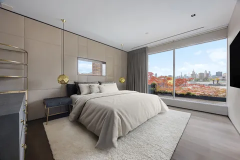 a bedroom with a large bed and a large window