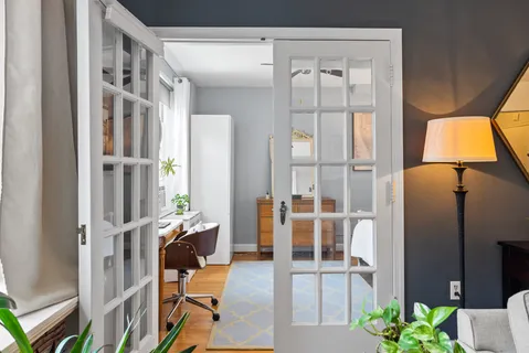 a bedroom with a bed a table and chair