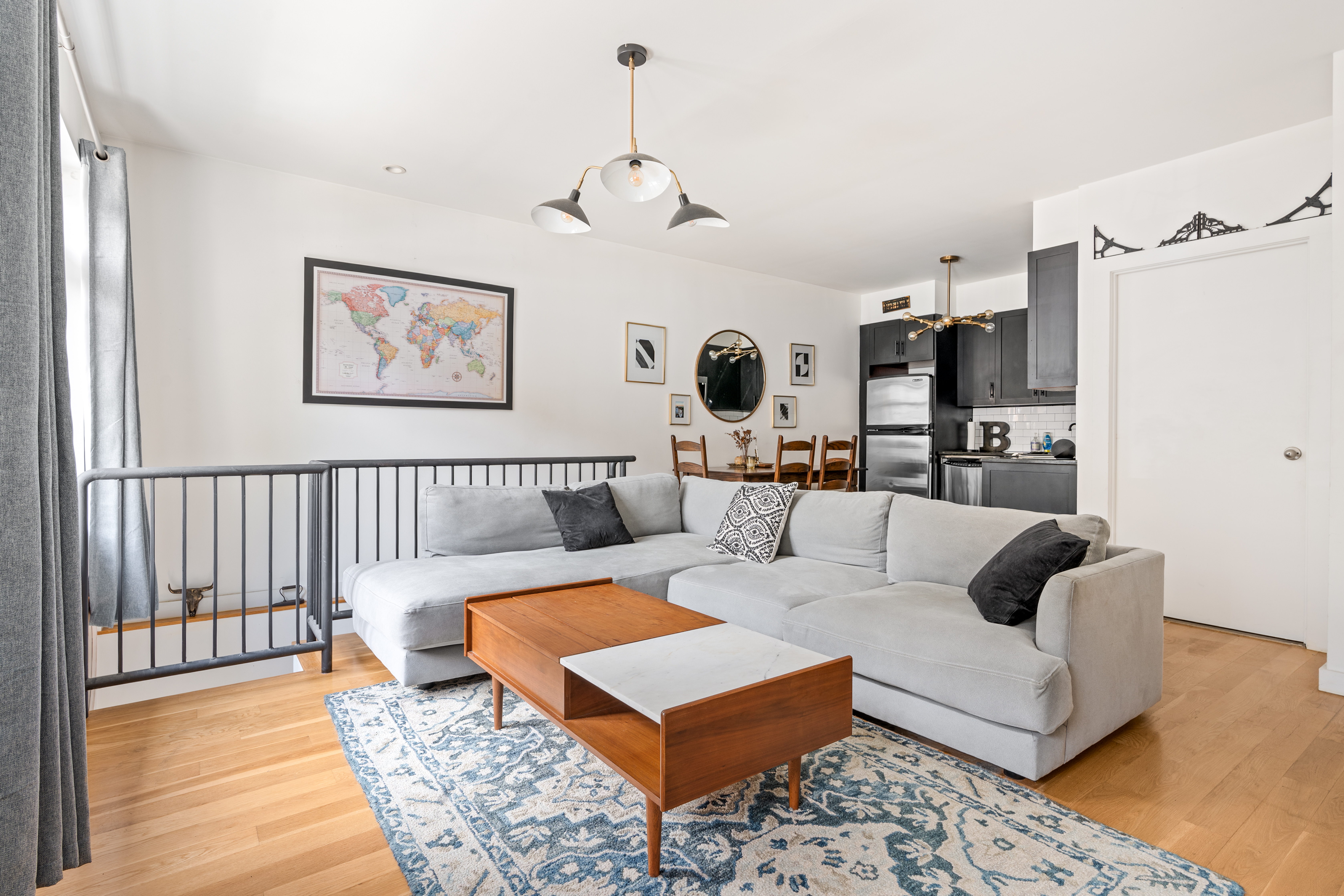 319 Humboldt Street, Unit 1A Brooklyn, NY 11211 - Photo 2 of 10 a living room with furniture and kitchen view