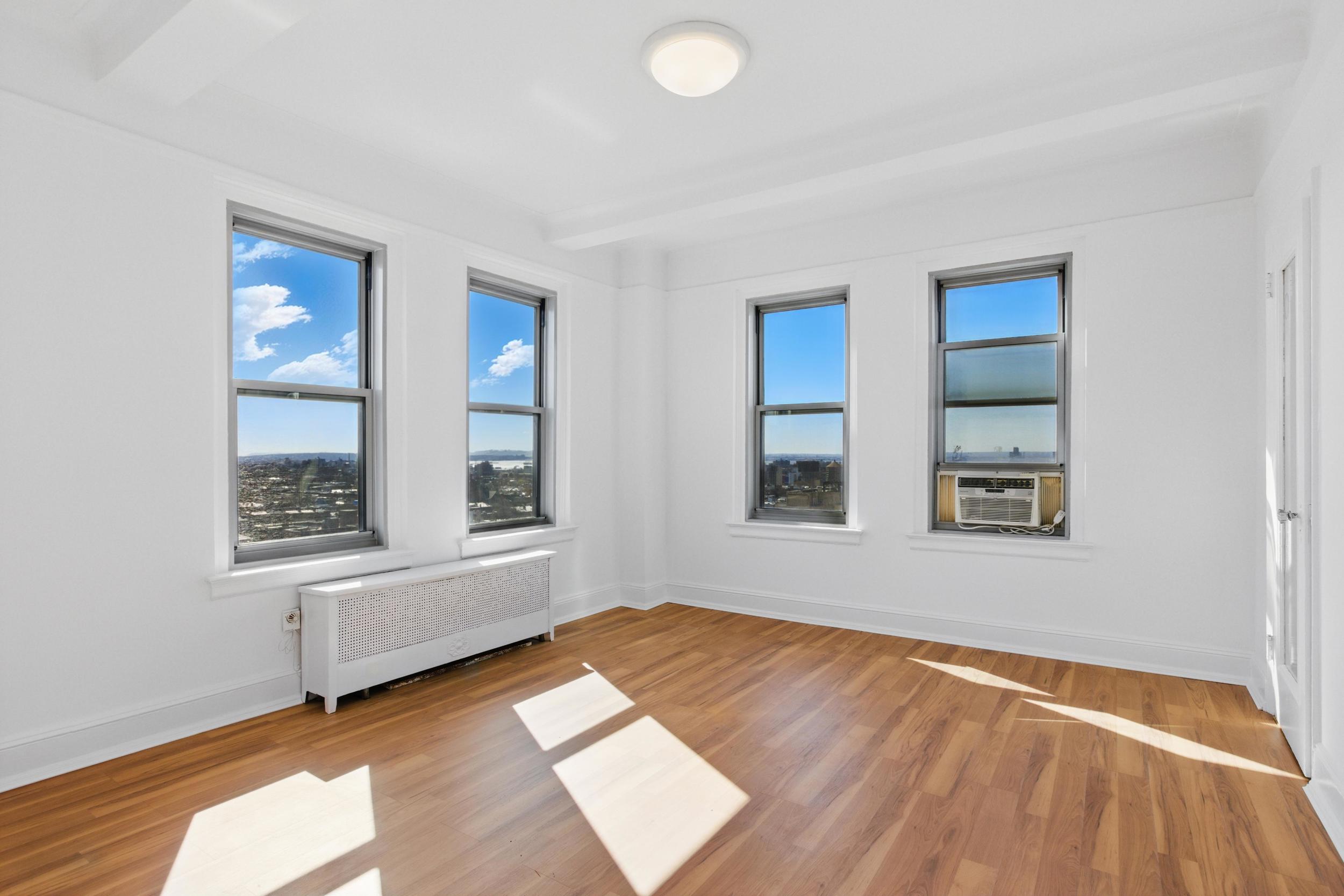 1 Plaza Street West, Unit 12C Brooklyn, NY 11217 - Photo 9 of 13 a view of an empty room with a window and wooden floor