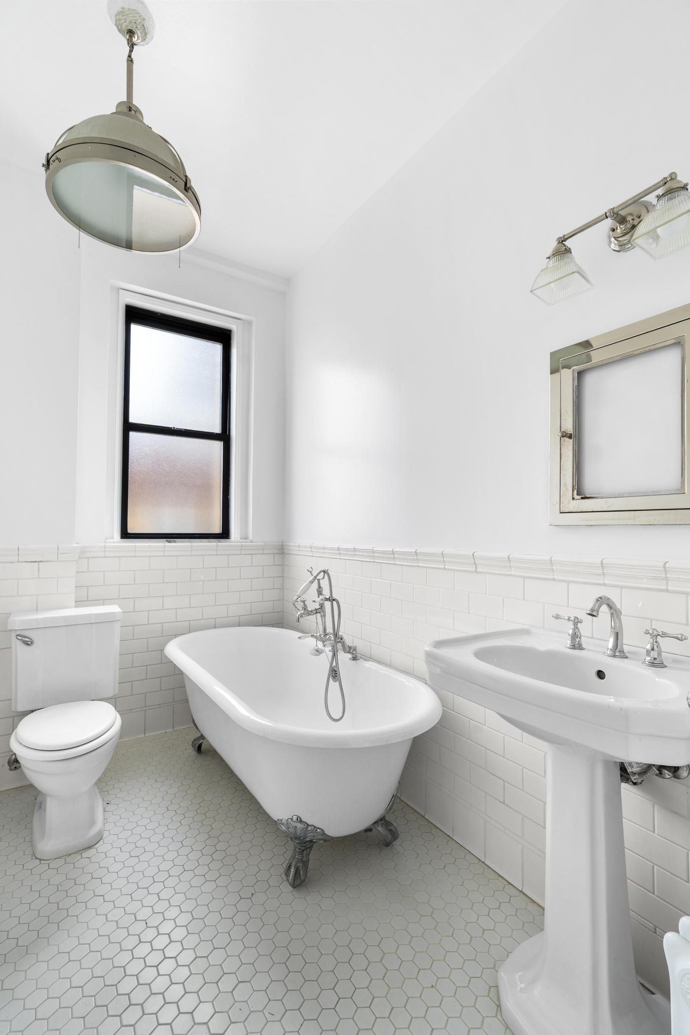 885 West End Avenue, Unit 12D Manhattan, NY 10025 - Photo 14 of 24 a bathroom with a toilet sink and mirror