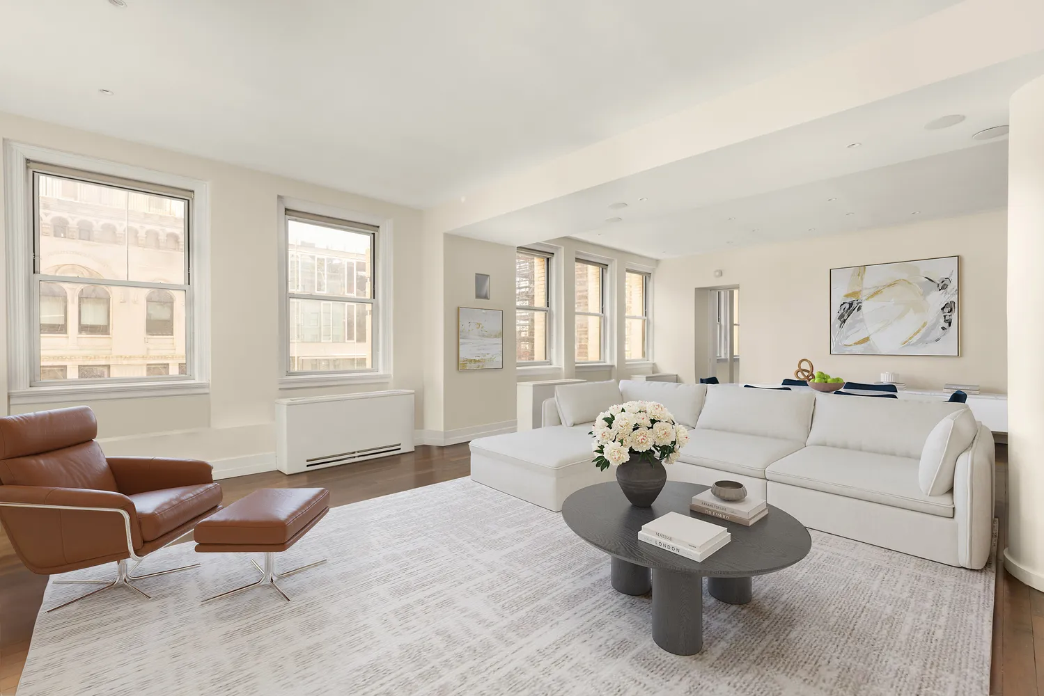 a living room with furniture and wooden floor