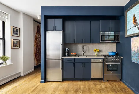 a kitchen with stainless steel appliances granite countertop a refrigerator stove top oven and sink