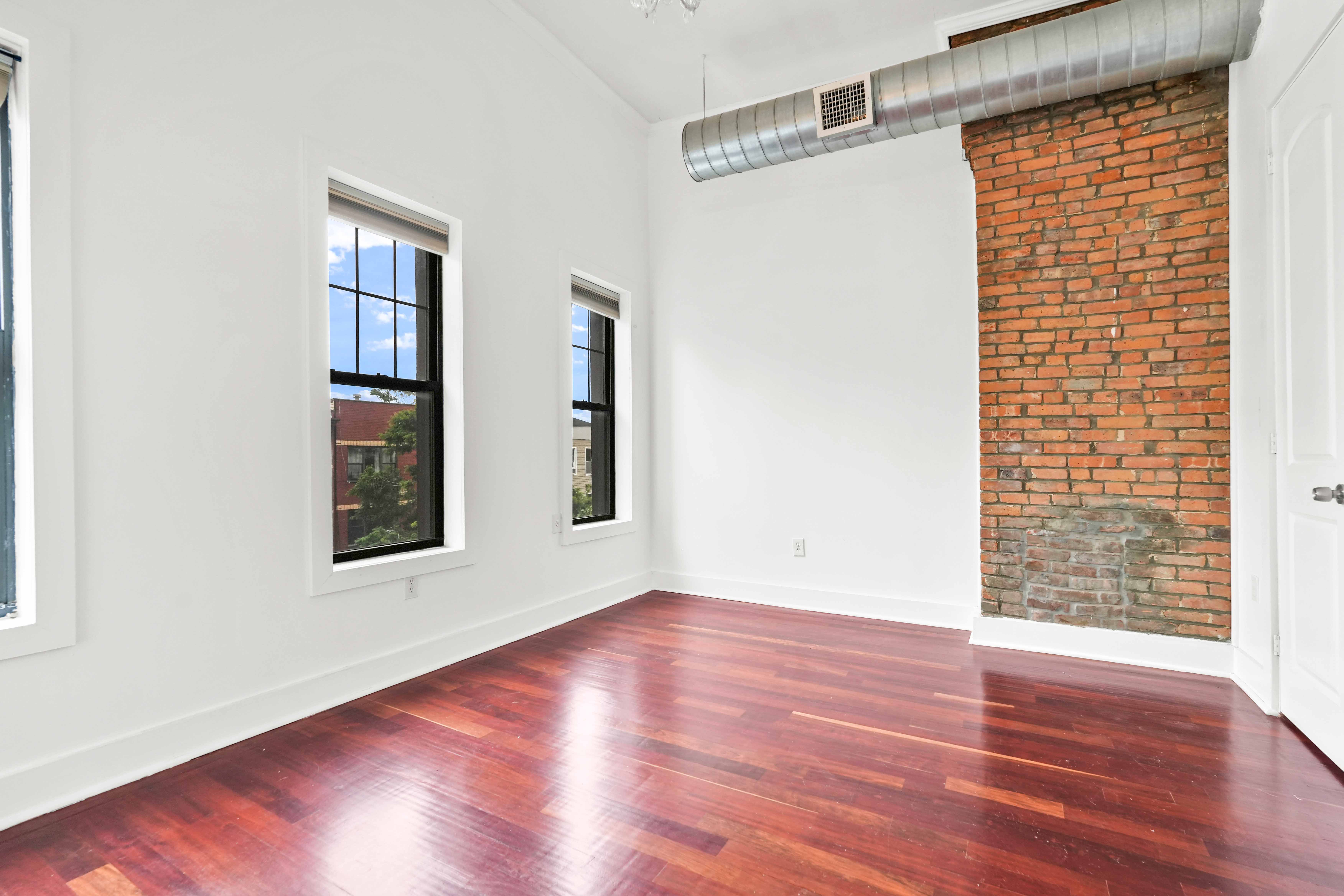 17 A Suydam Place, Unit 2 Brooklyn, NY 11233 - Photo 16 of 28 a view of an empty room with wooden floor and a window