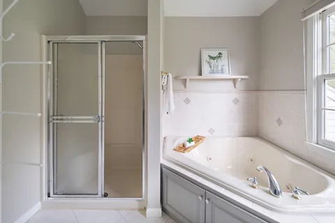 a bathroom with a bathtub and a window