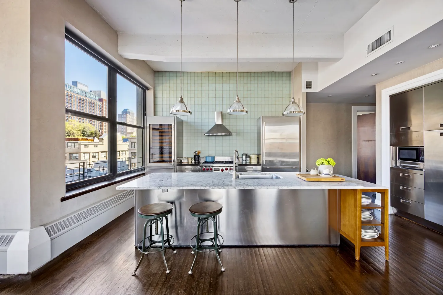 a kitchen with counter top space and wooden floor