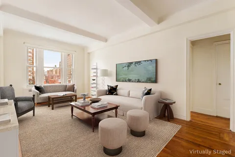 a living room with furniture wooden floor and a large window