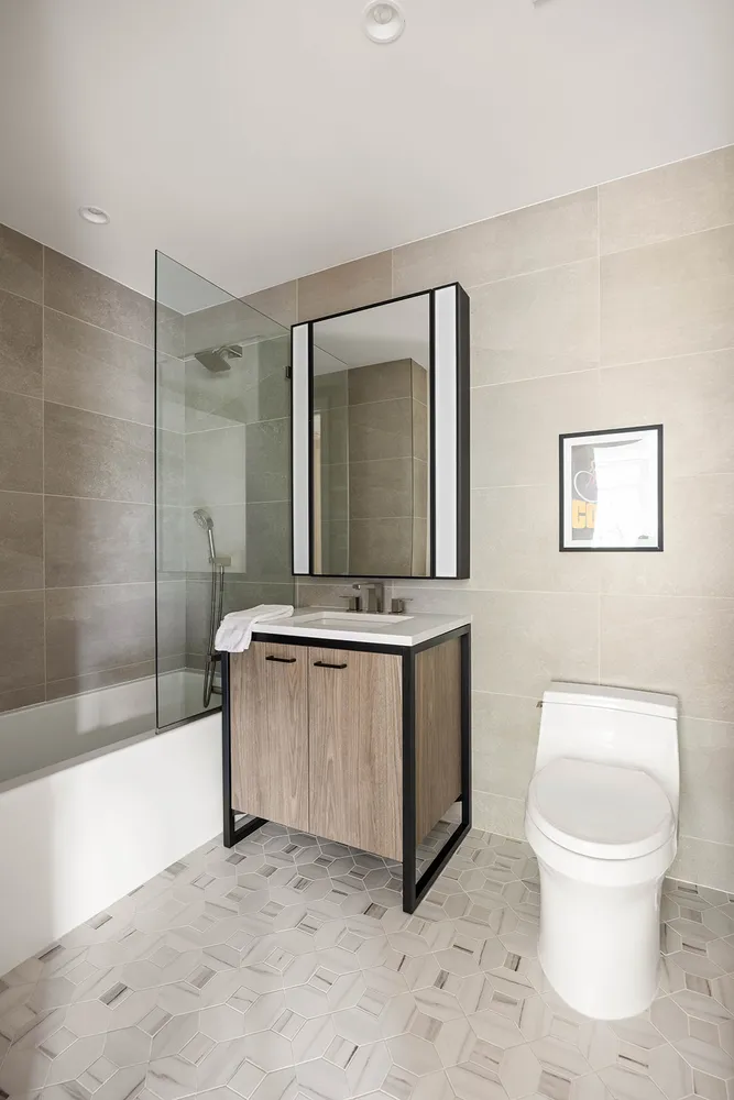 a bathroom with a sink a toilet and shower