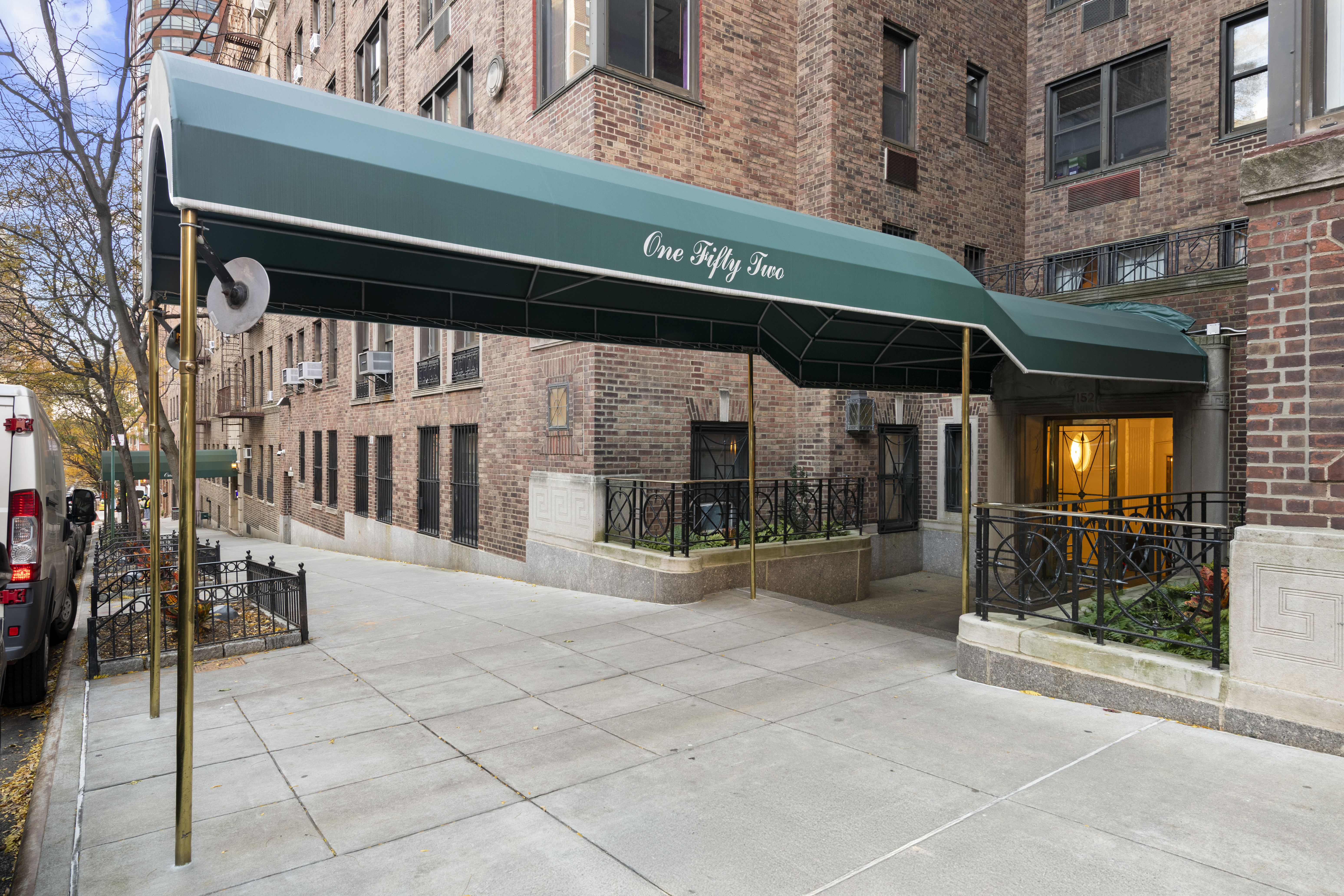 152 East 94th Street, Unit 2J Manhattan, NY 10128 - Photo 17 of 18 a view of a building with a door and a car parked