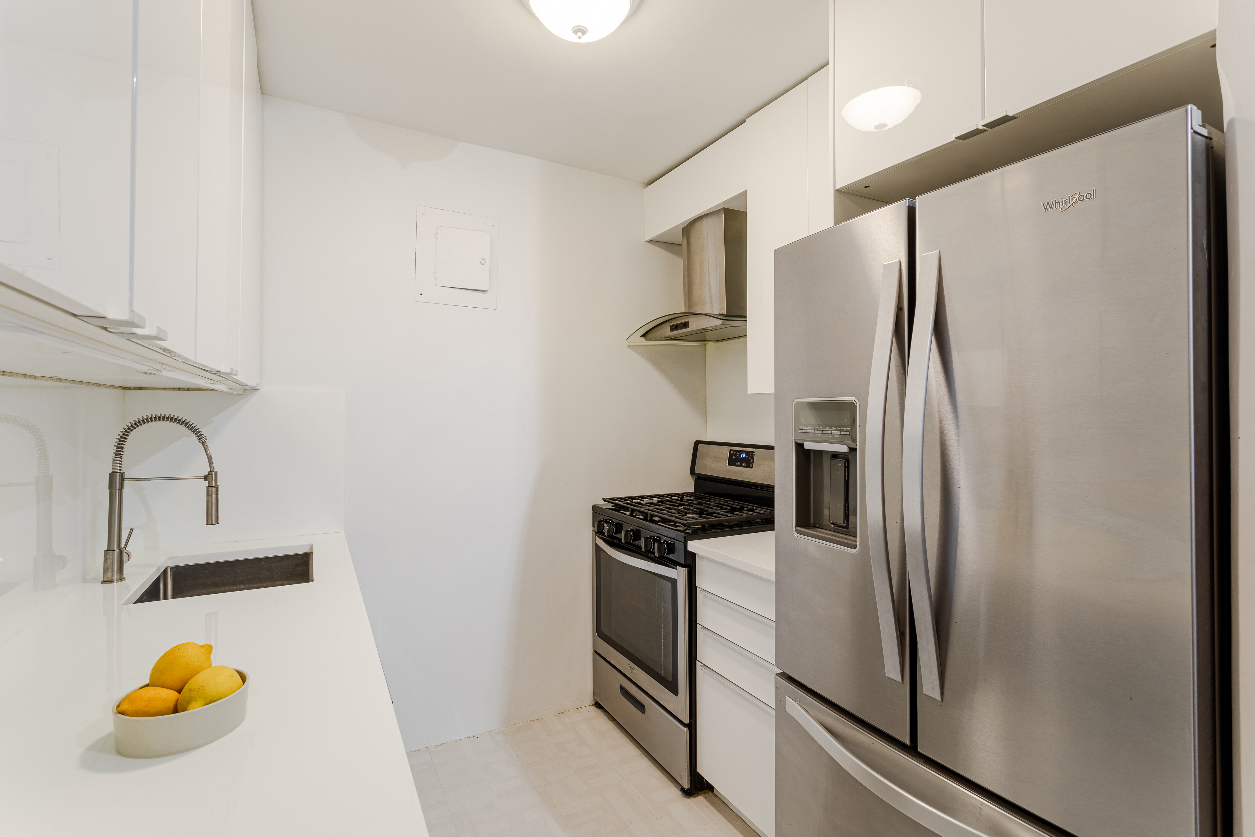 155 East 38th Street, Unit 10D Manhattan, NY 10016 - Photo 11 of 15 a kitchen with a refrigerator sink and stove