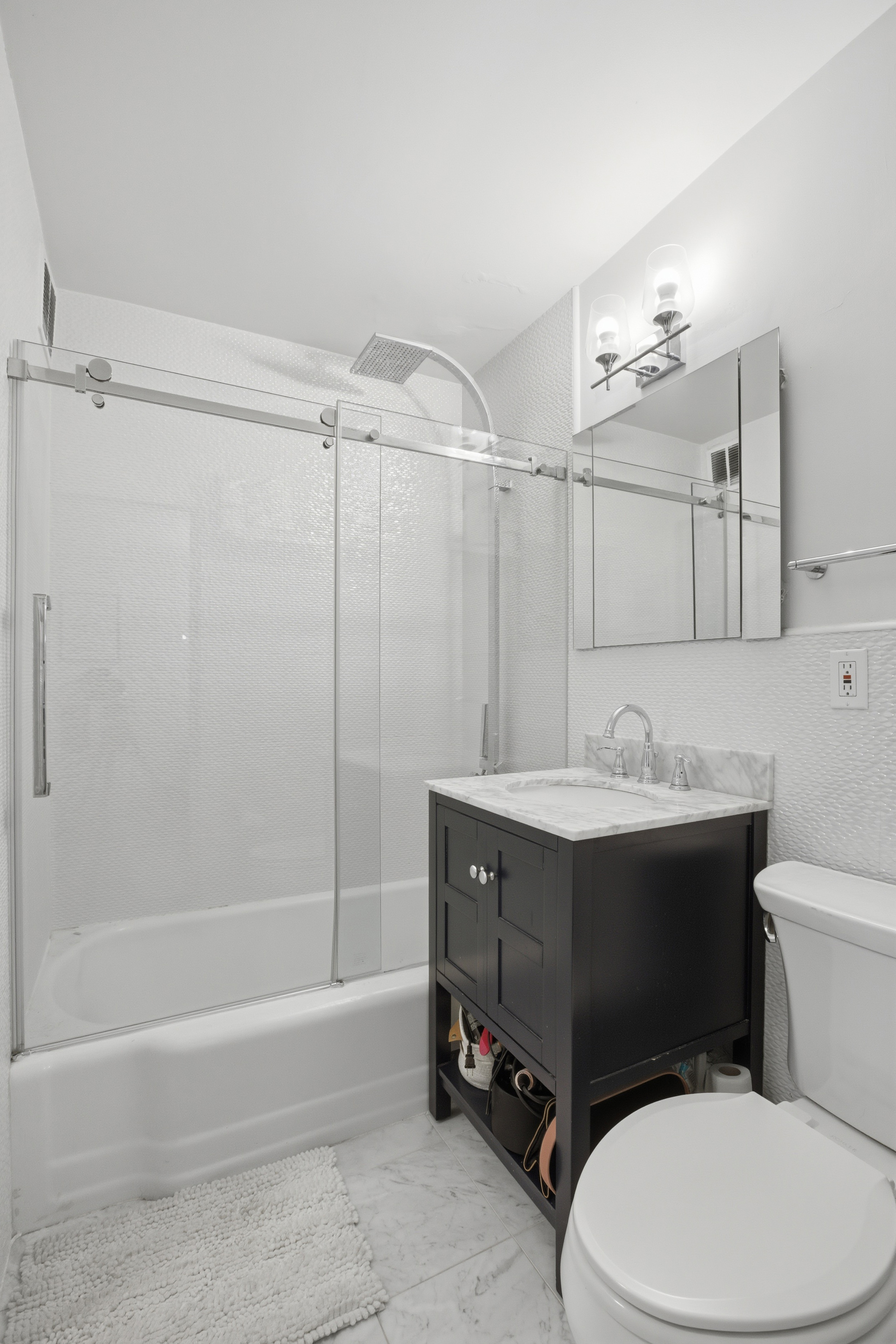 345 East 81st Street, Unit 9D Manhattan, NY 10028 - Photo 16 of 17 a bathroom with a sink a toilet and shower