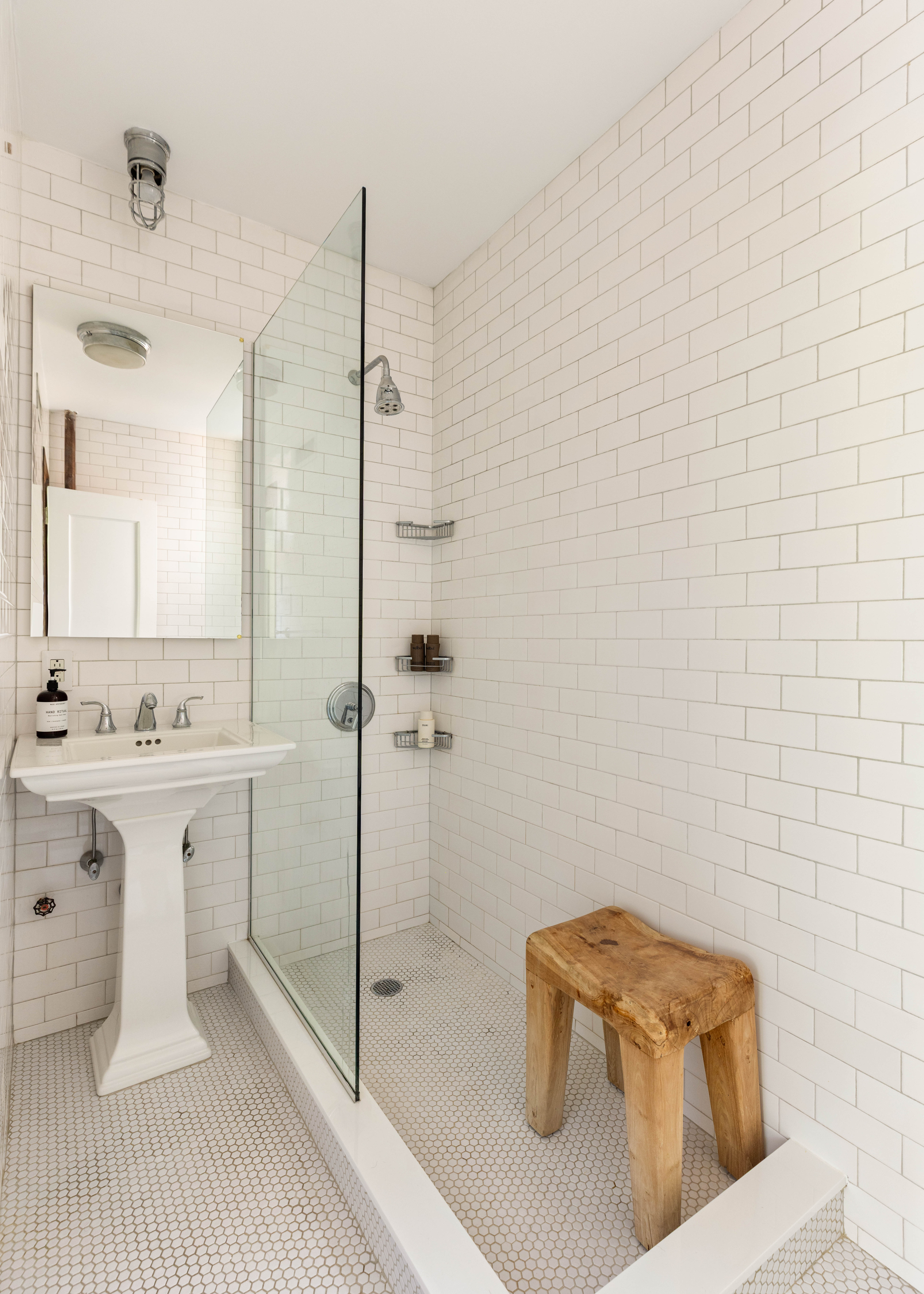 253 West 16th Street, Unit 5C Manhattan, NY 10011 - Photo 8 of 11 a bathroom with a sink a toilet a mirror and shower