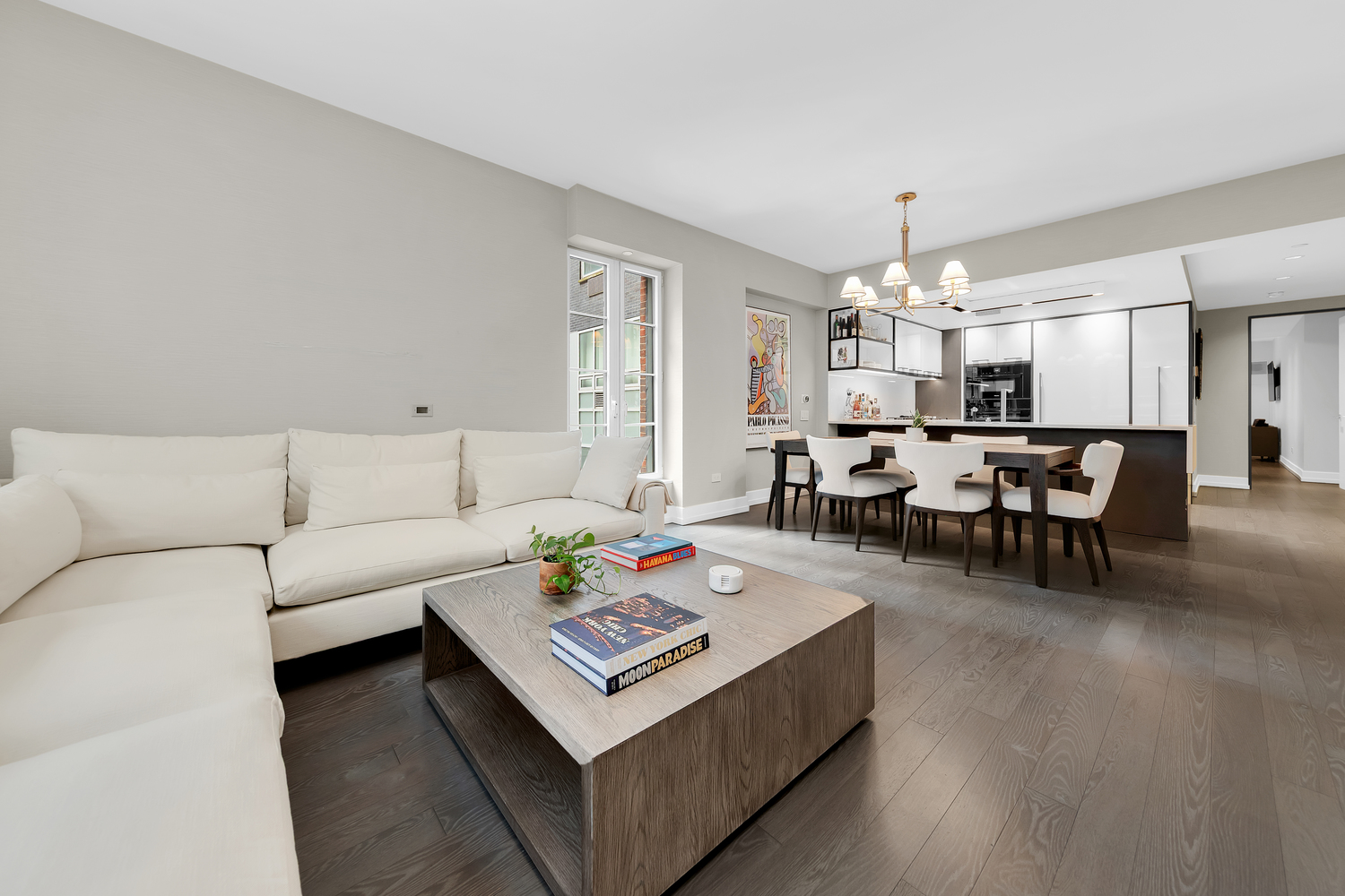 70 Charlton Street, Unit 3F Manhattan, NY 10014 - Photo 3 of 15 a living room with furniture and a chandelier