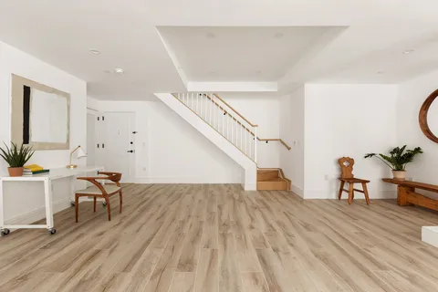 a view of a livingroom with furniture and wooden floor