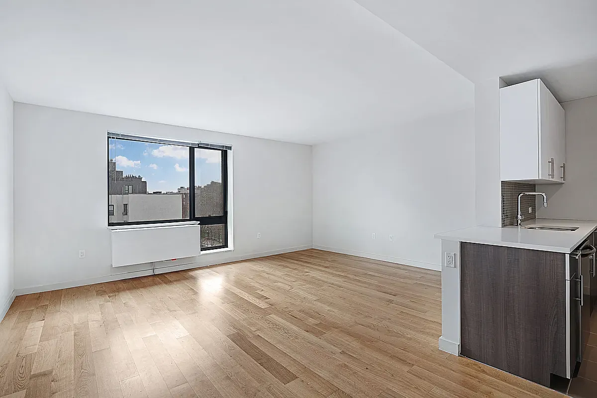 44-72 11th Street, Unit A403 Queens, NY 11101 - Photo 2 of 12 a view of an empty room with wooden floor and a window
