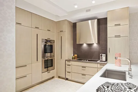 a kitchen with a refrigerator and a sink