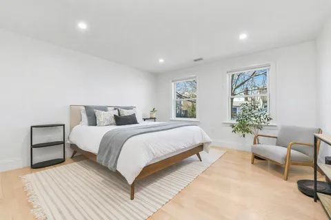 a bedroom with a large bed and a couch