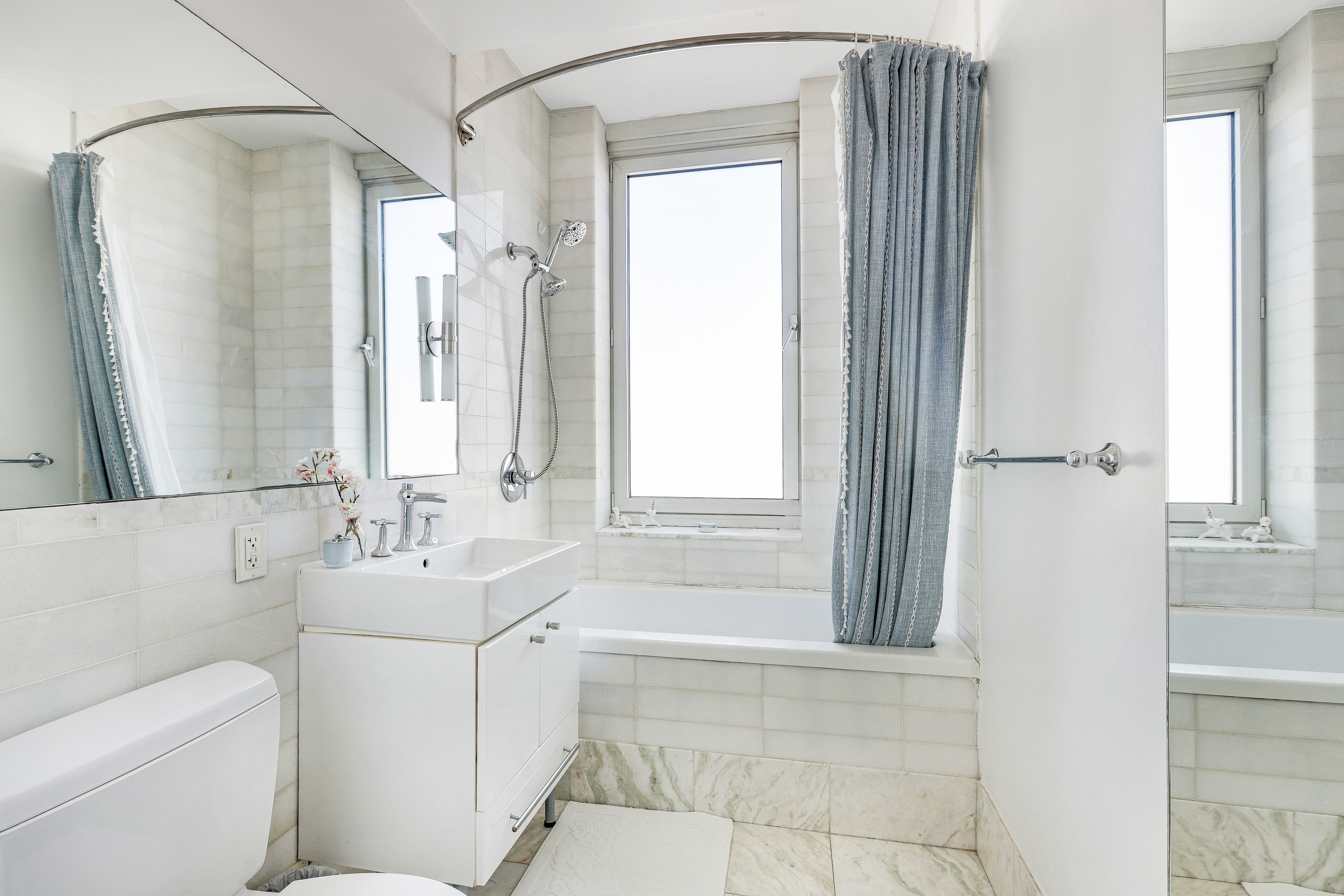 635 West 42nd Street, Unit 34B Manhattan, NY 10036 - Photo 5 of 10 a bathroom with a sink a toilet and shower