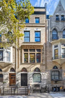 a front view of a residential apartment building with a yard