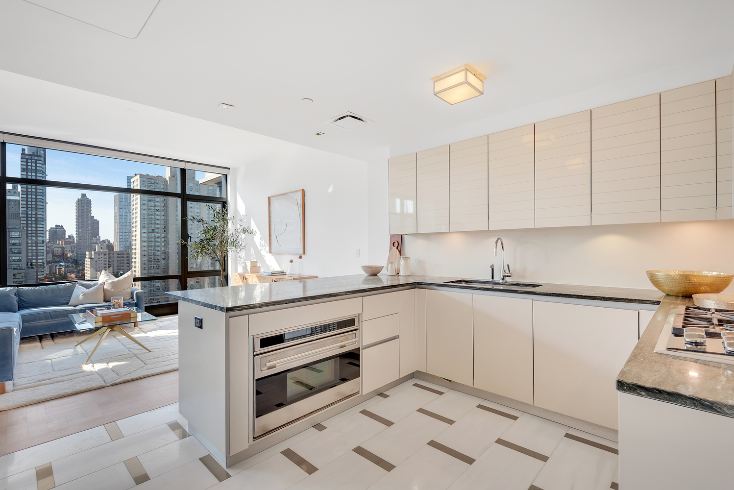 170 East End Avenue, Unit 16B Manhattan, NY 10128 - Photo 9 of 21 a kitchen with granite countertop white cabinets and white appliances