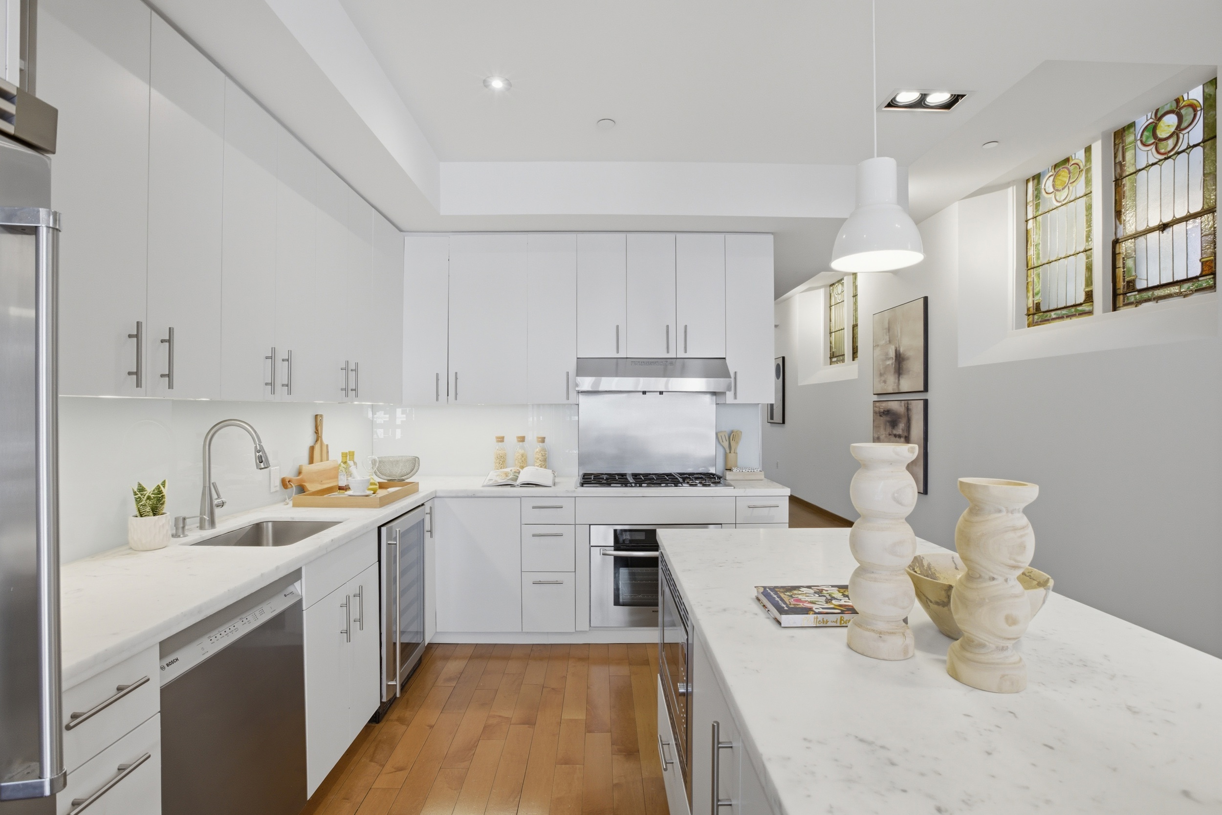 135 West 4th Street, Unit 2W Manhattan, NY 10012 - Photo 9 of 20 a kitchen with a sink stove and cabinets