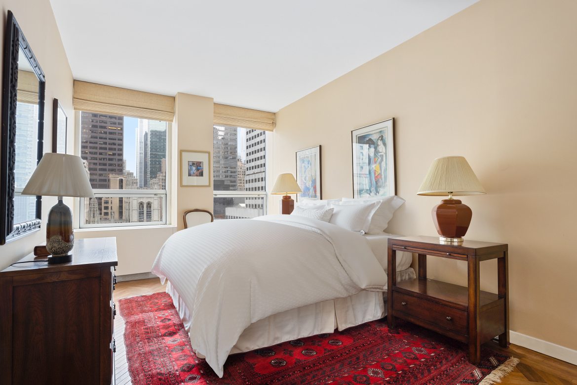 15 West 53rd Street, Unit 11H Manhattan, NY 10019 - Photo 6 of 11 a bedroom with a bed and window