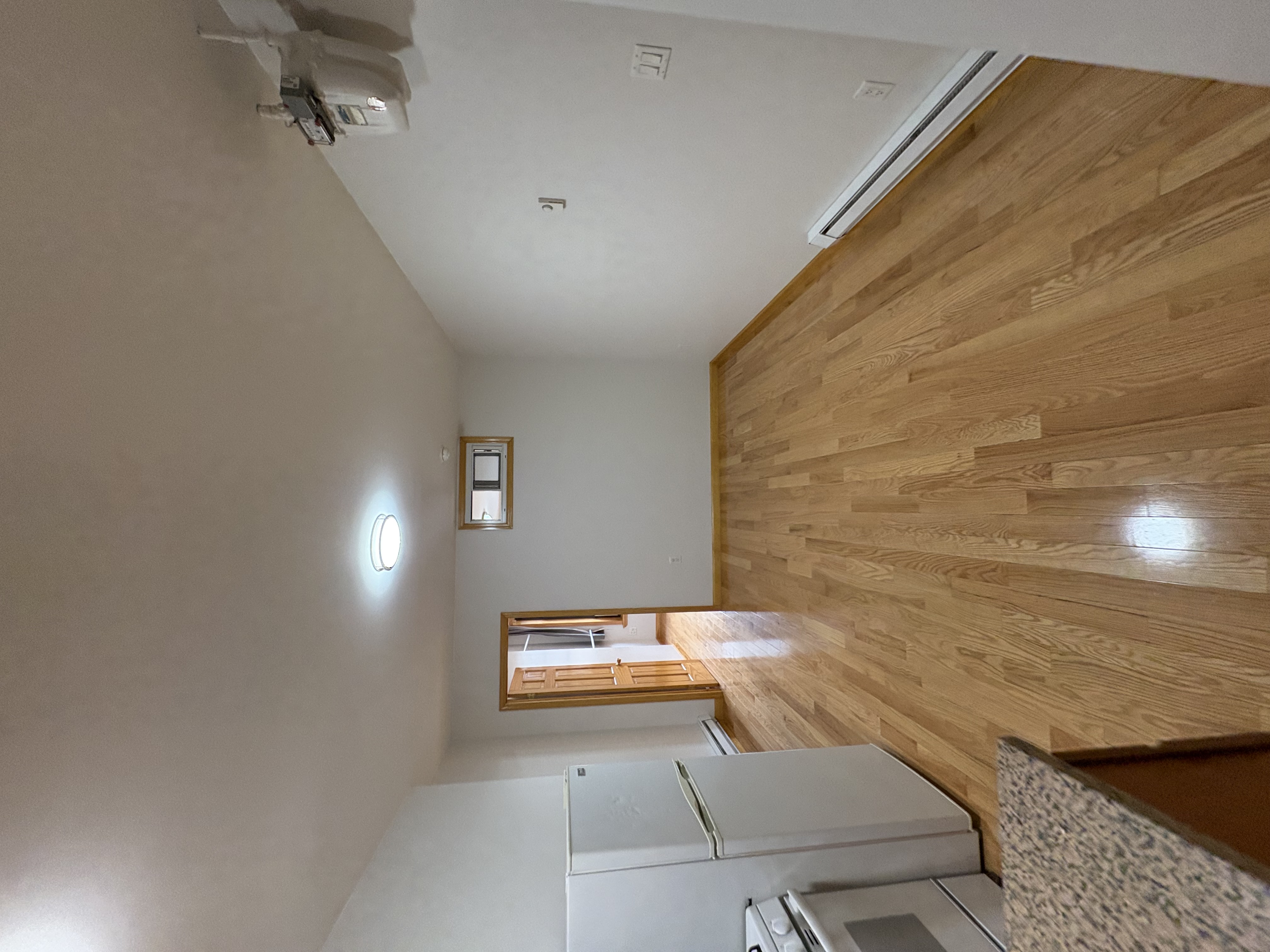 38 Ludlow Street, Unit 15 Manhattan, NY 10002 - Photo 6 of 16 a view of empty room with a fireplace and wooden floor