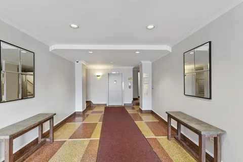 a hallway with a black white checkered floor